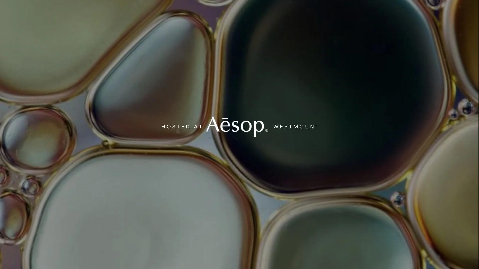 Title hosted at Aesop over shiny bubbles of liquid
