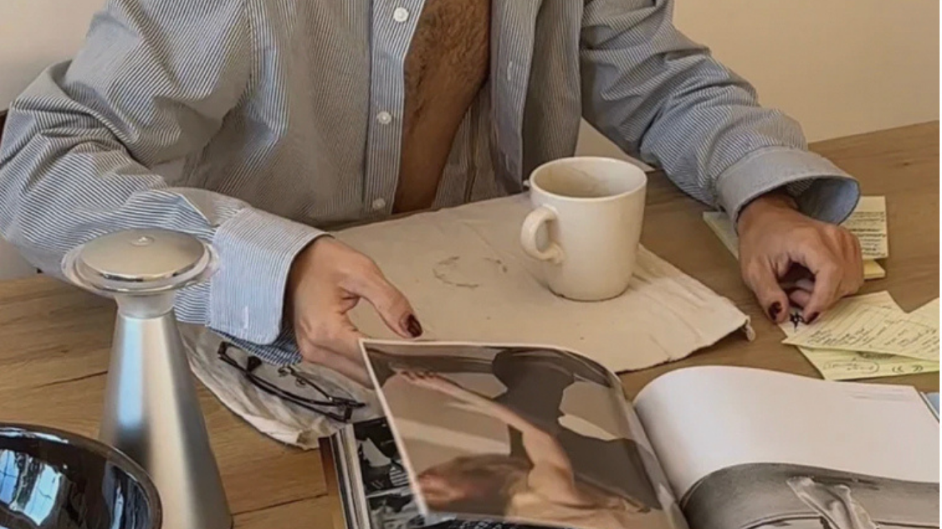 Person having their morning coffee and sorting through a magazine