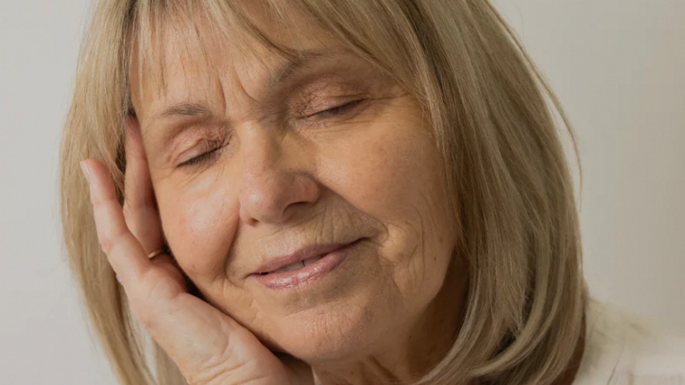 Mature woman holding her face