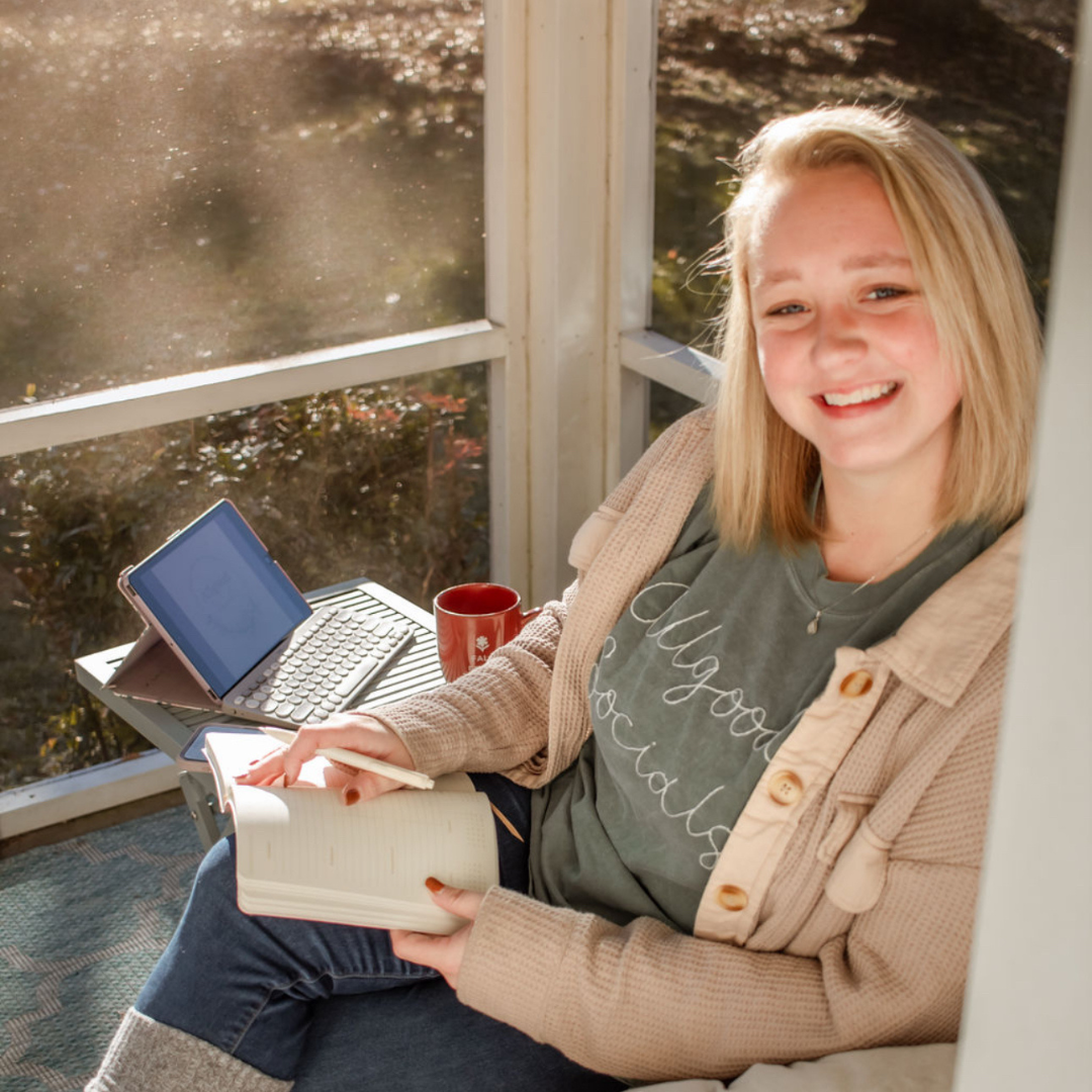 social media manager working outside and taking notes, happy and healthy working hard.
