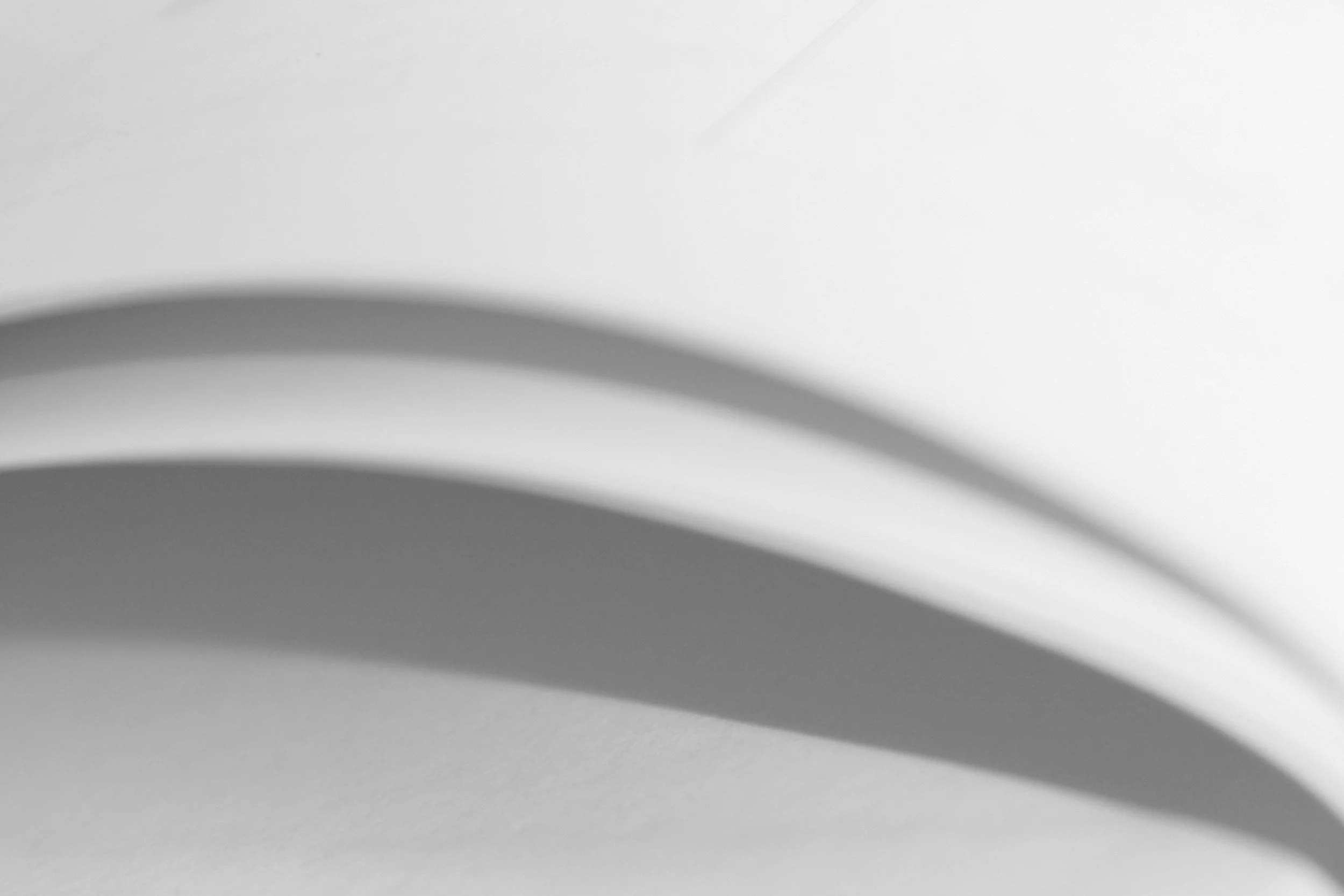 Abstract close-up of curved white paper with shadows