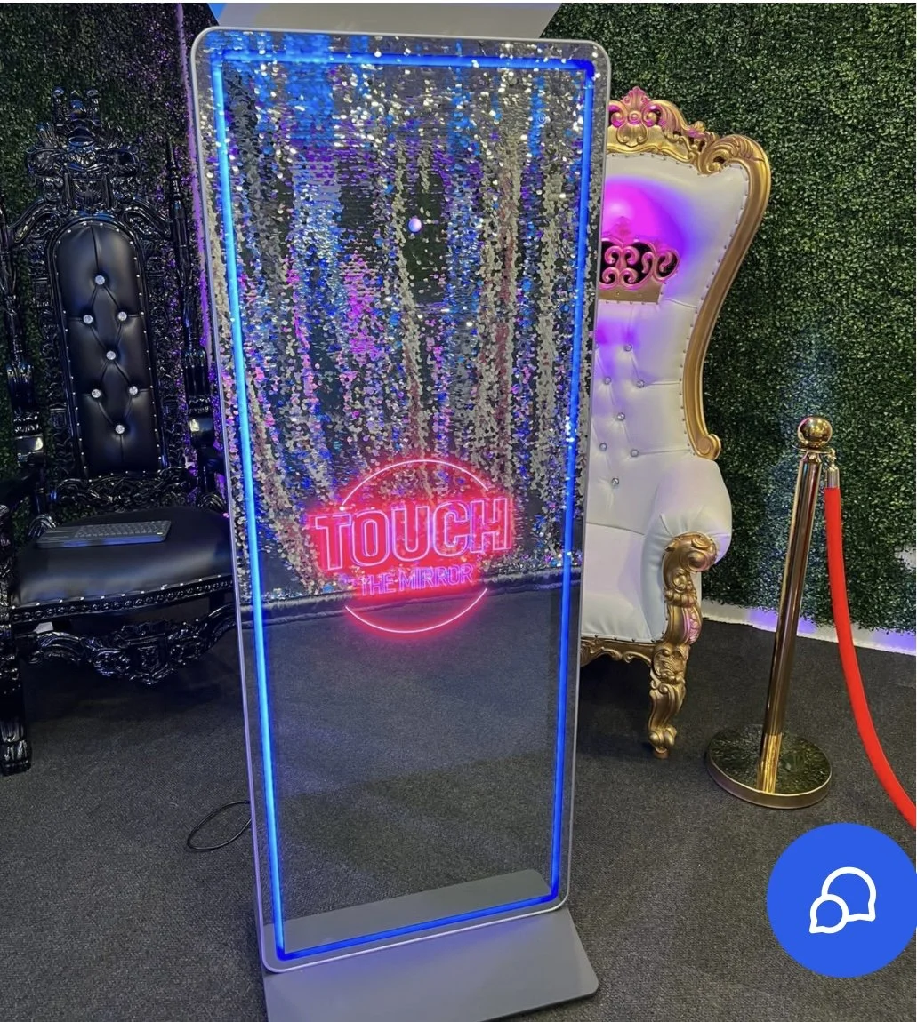 The mirror is equipped with a touch screen that encourages users to engage with various features, such as adding digital props, customizing messages, and selecting filters.
