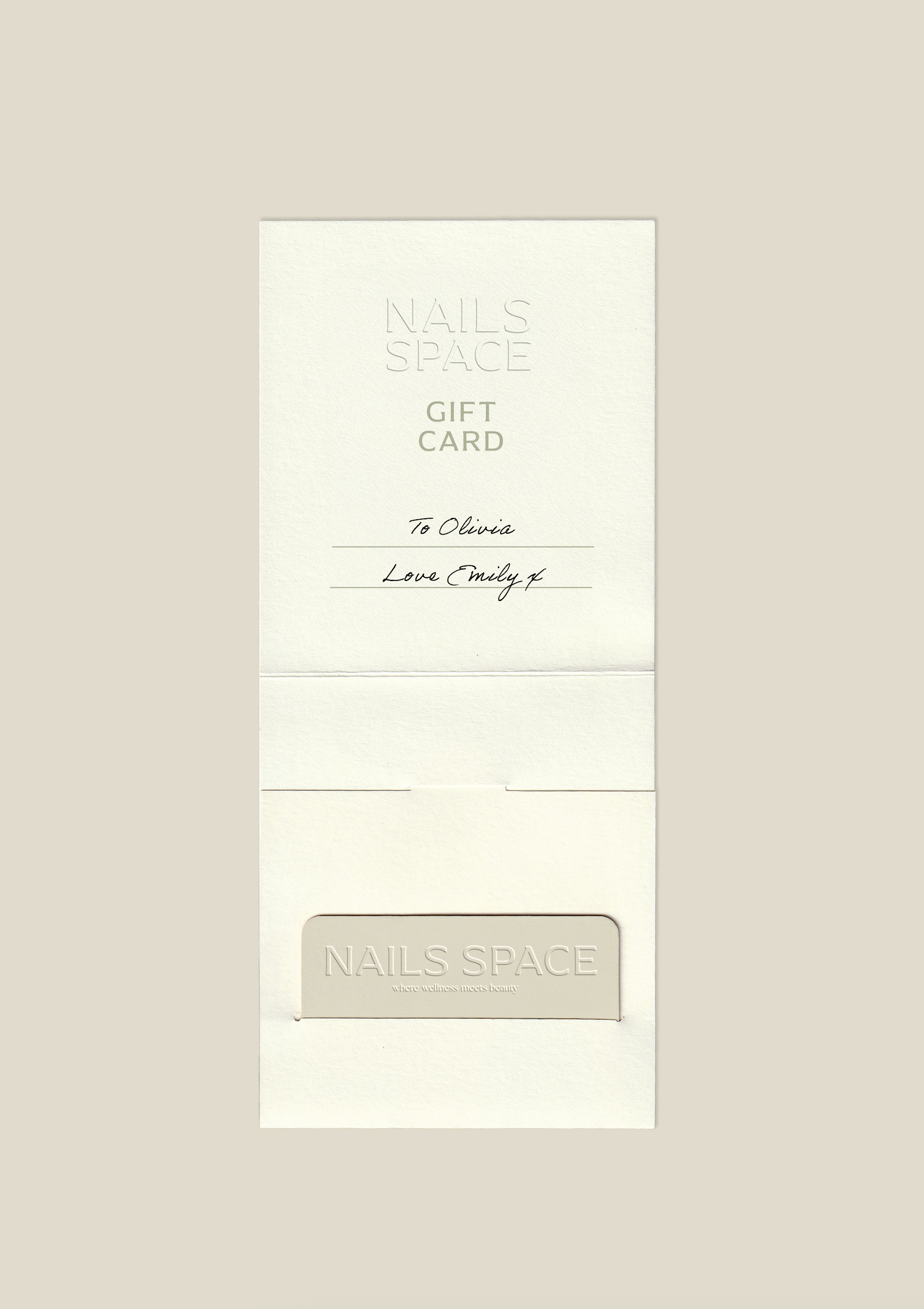 A white gift card and a white NAILS SPACE loyalty card with embossed text and a handwritten note that says "To Olivia" and "Love Emily".