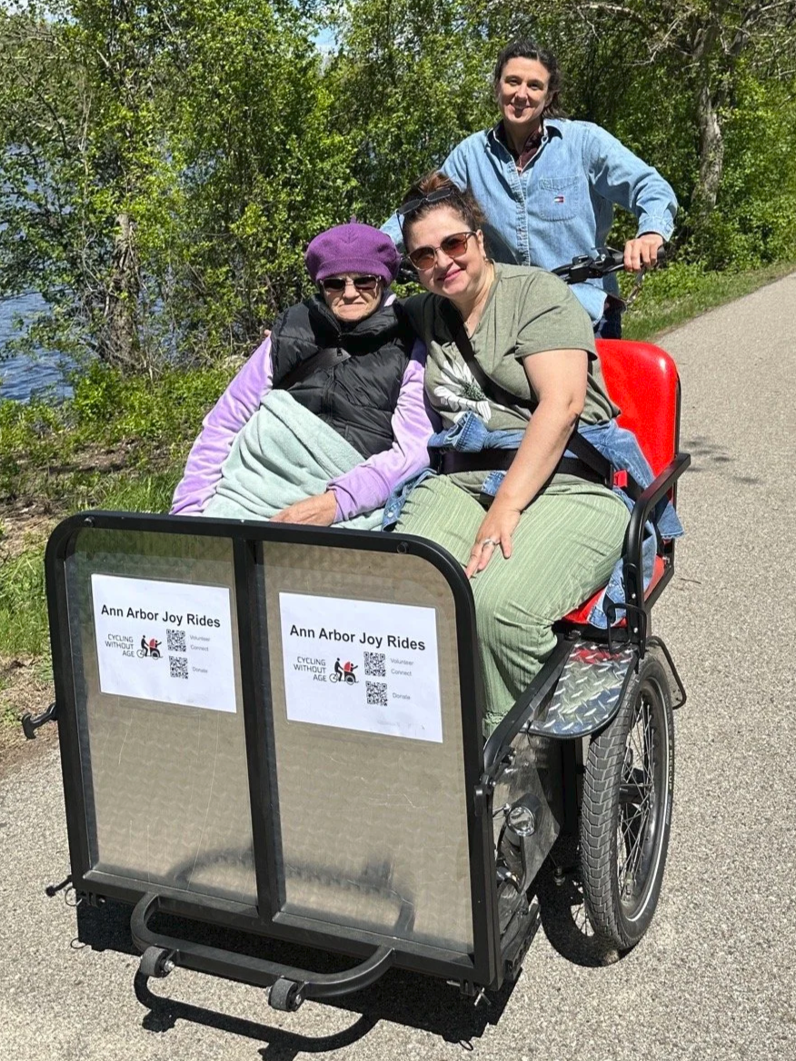 Meg as pilot for Trishaw, Camelia and her senior mother Marie are in the front seat of bike smiling on the B to B trail