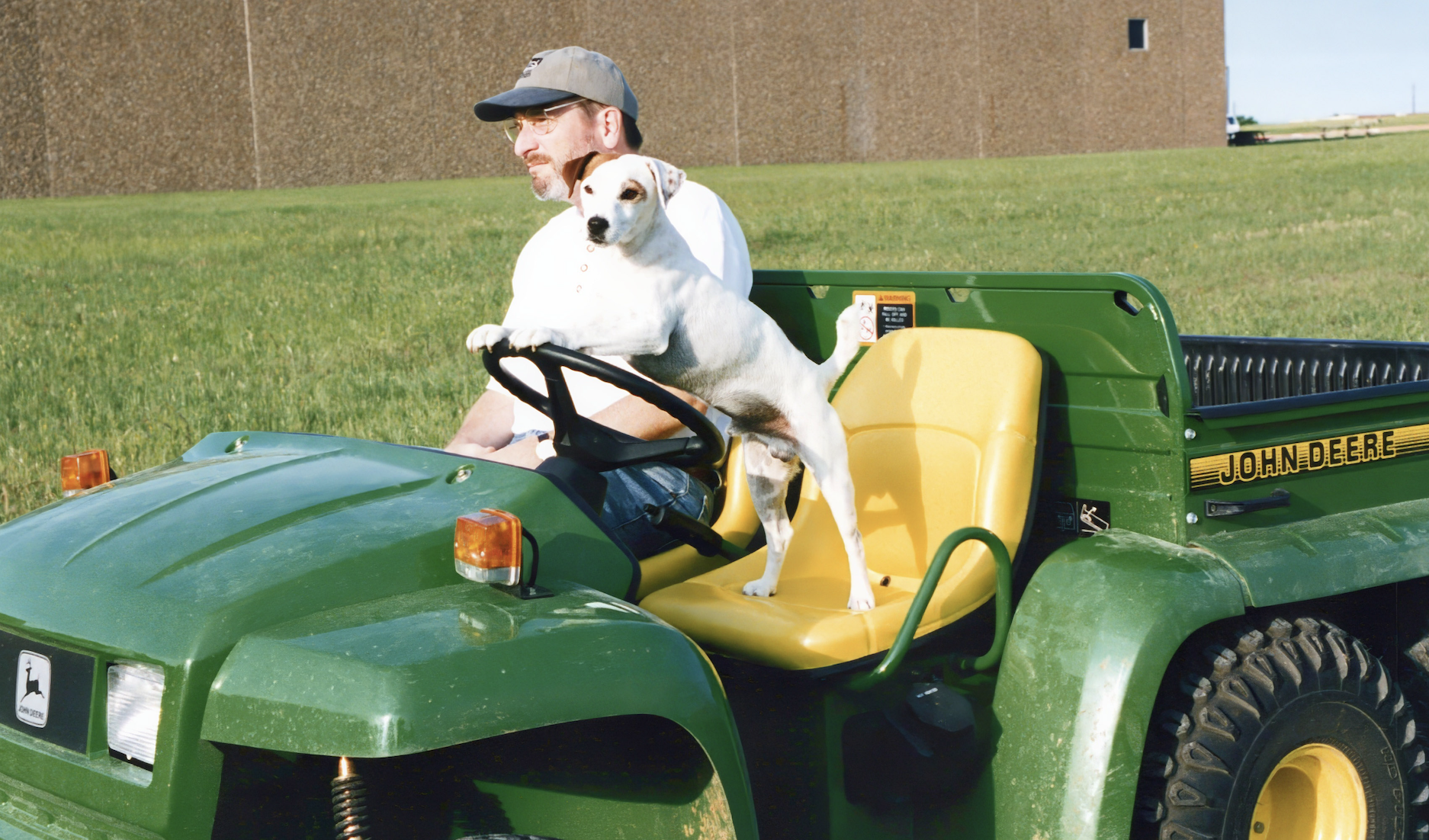 Soccer and Rick hanging out between takes on a tractor