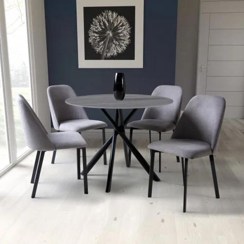 Modern dining table with five gray chairs and a black vase on top, against a blue wall with black and white floral wall art.