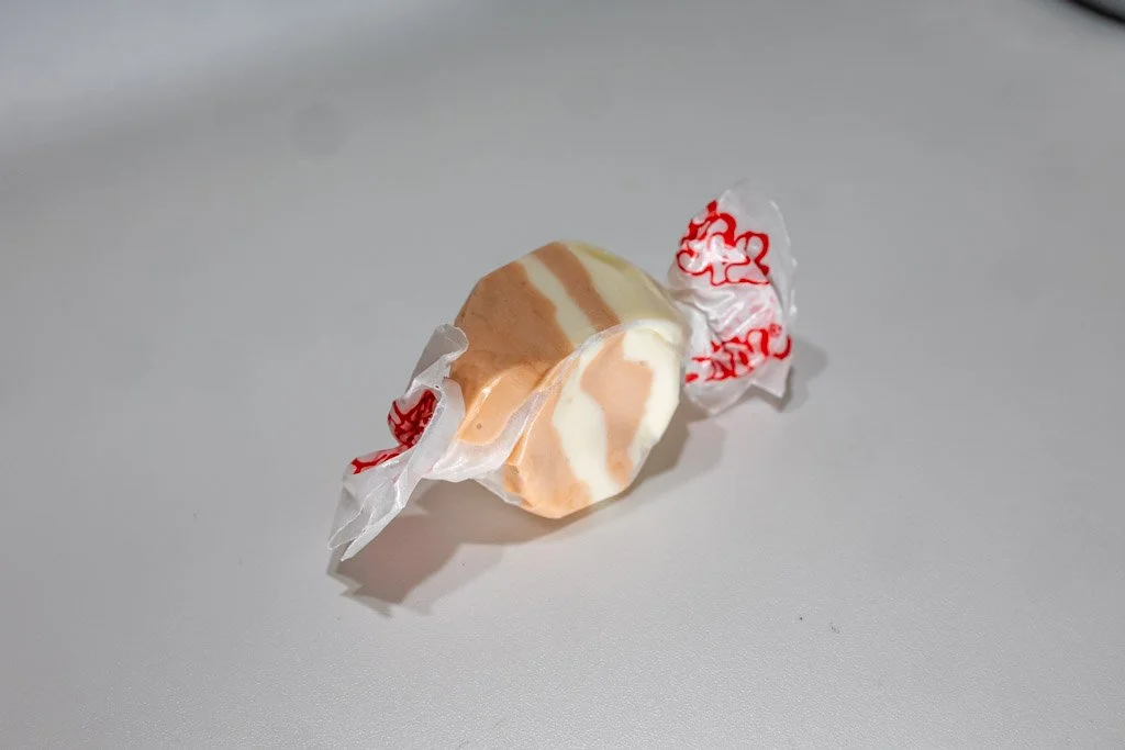 White and tan striped coconut saltwater taffy from Sea Bird Gifts & Candy in Westport WA. Creamy tropical-flavored taffy wrapped in wax paper.