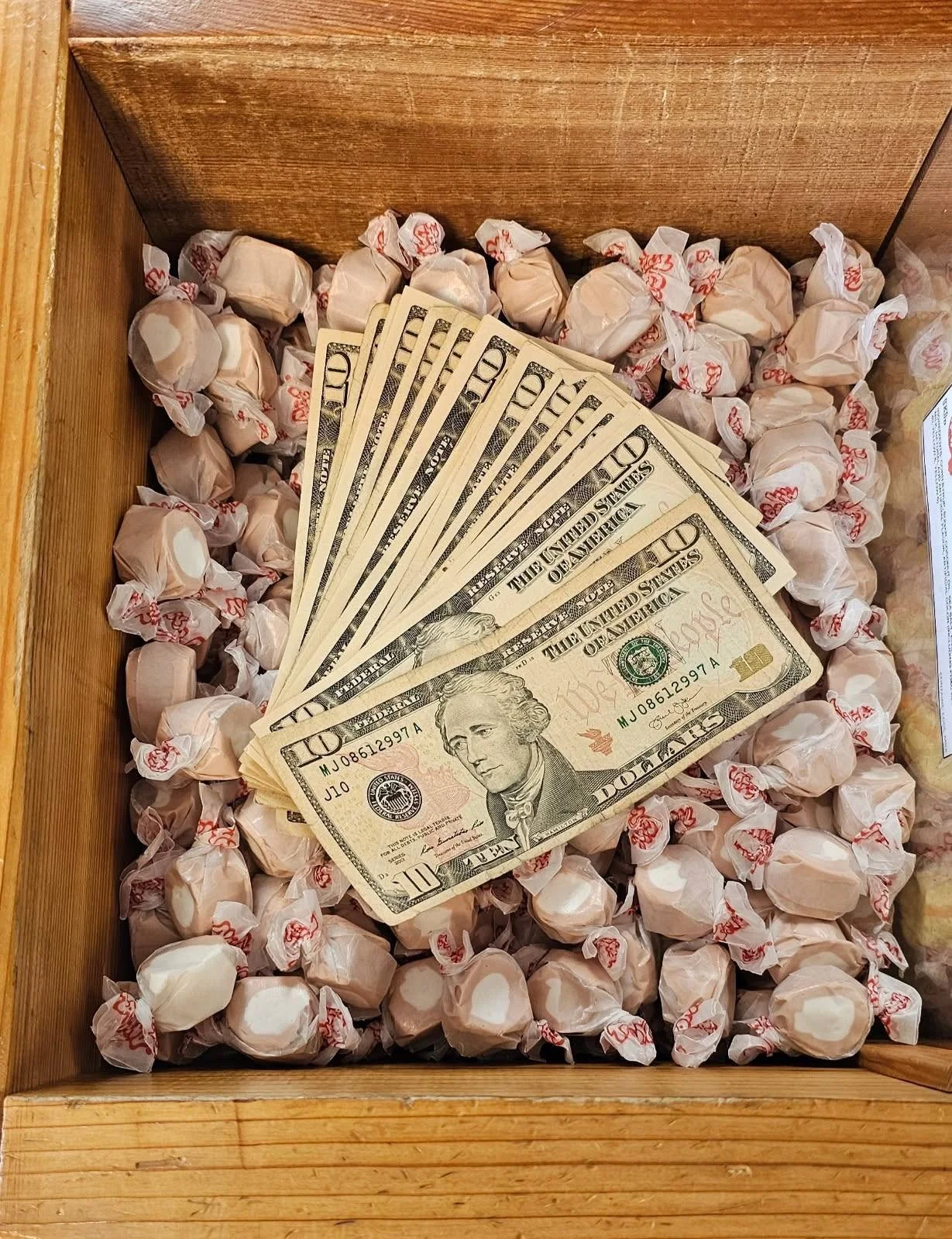 and image of some US dollars hidden in a taffy bin at Sea birds candy and gifts during pirate daze festival in westport, wa