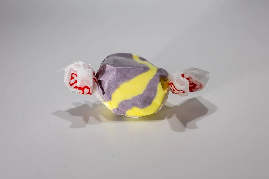 ellow and purple raspberry lemonade saltwater taffy from Sea Bird Gifts & Candy in Westport WA. Bright citrus and berry swirl taffy wrapped in wax paper.