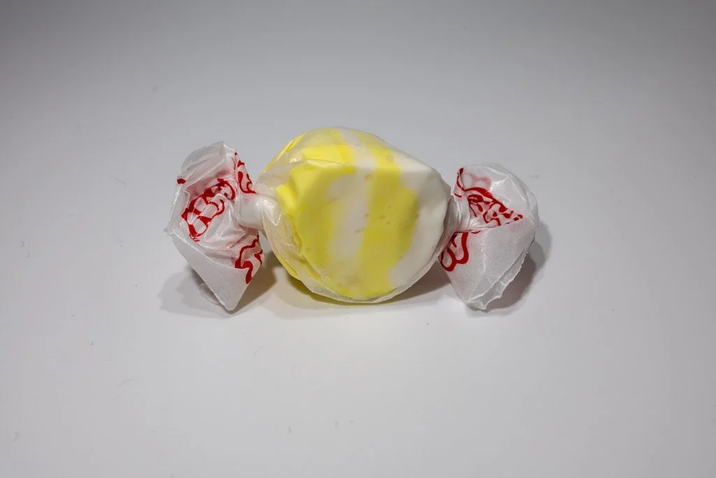 Yellow and white buttered popcorn saltwater taffy from Sea Bird Gifts & Candy in Westport WA. Sweet and salty taffy wrapped in classic wax paper