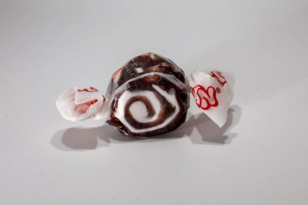 Black and white licorice swirl saltwater taffy from Sea Bird Gifts & Candy in Westport WA. Striking dark taffy with creamy white spiral, wrapped in wax paper