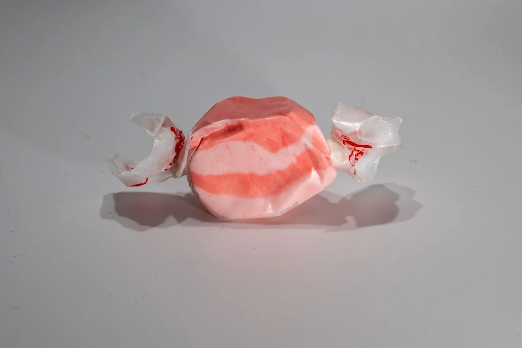 ink and white striped cran raspberry saltwater taffy from Sea Bird Gifts & Candy in Westport WA. Fruity berry-flavored taffy wrapped in wax paper.