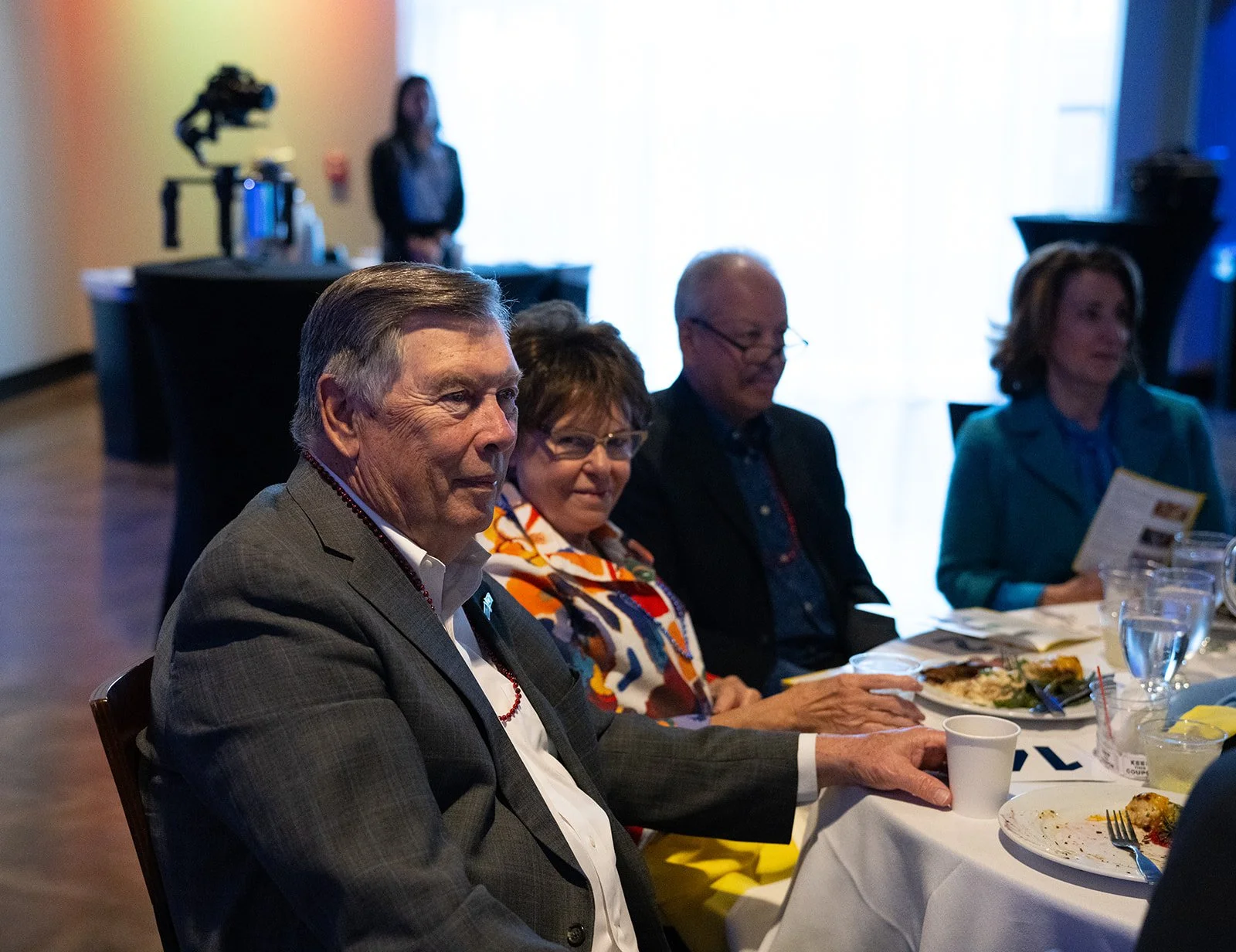 Group of people at a dining table during an event