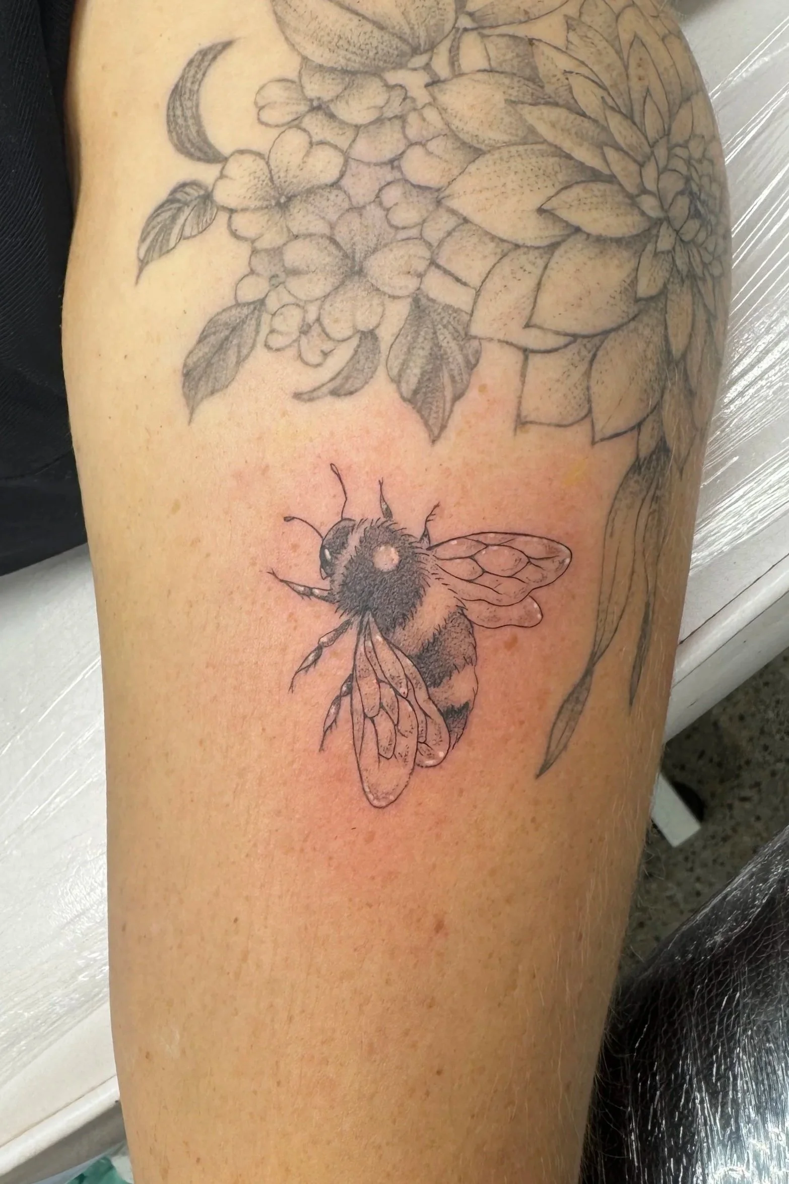 Tiny small fine bumble bee tattoo done in South Island 