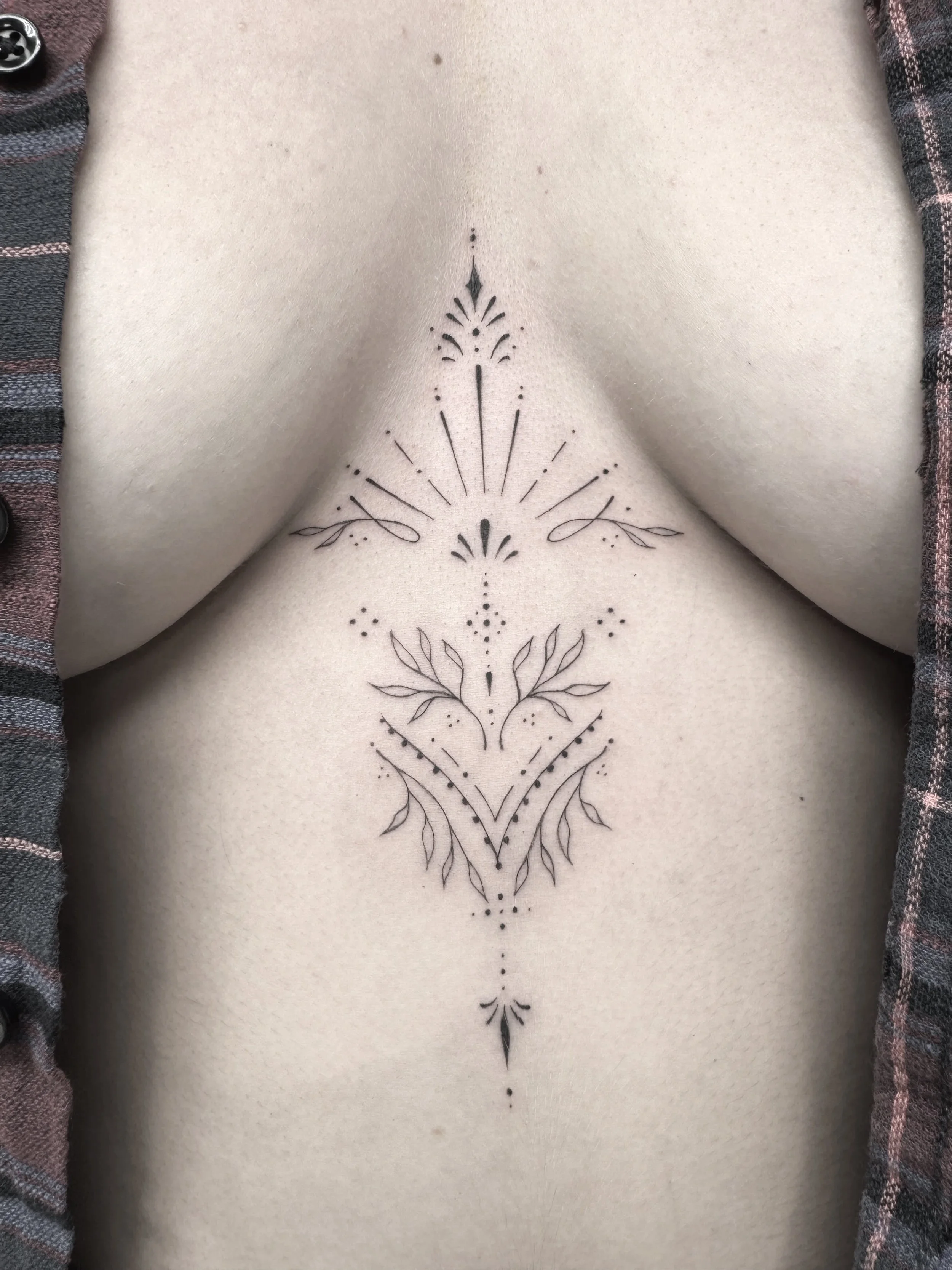 Ornamental New Zealand Queenstown tattoo chest sternum