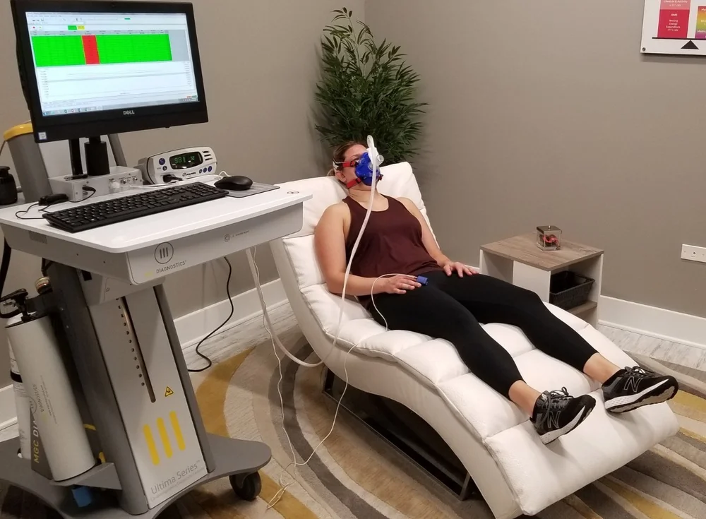 A client completing an RMR metabolism breath test at DexaFit