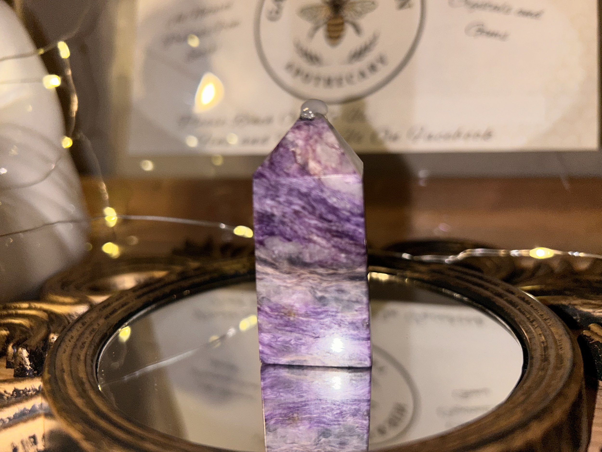 Polished Charoite crystal towers with deep purple and pink swirls, used for transformation, spiritual insight, and intuitive awakening.