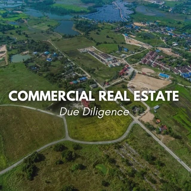 Aerial view of a large green area with roads and buildings, indicating commercial real estate development.