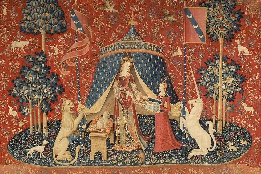 A medieval tapestry featuring a king and queen in a regal tent, surrounded by various animals including lions, unicorns, and birds, with trees and decorative motifs on a red background.