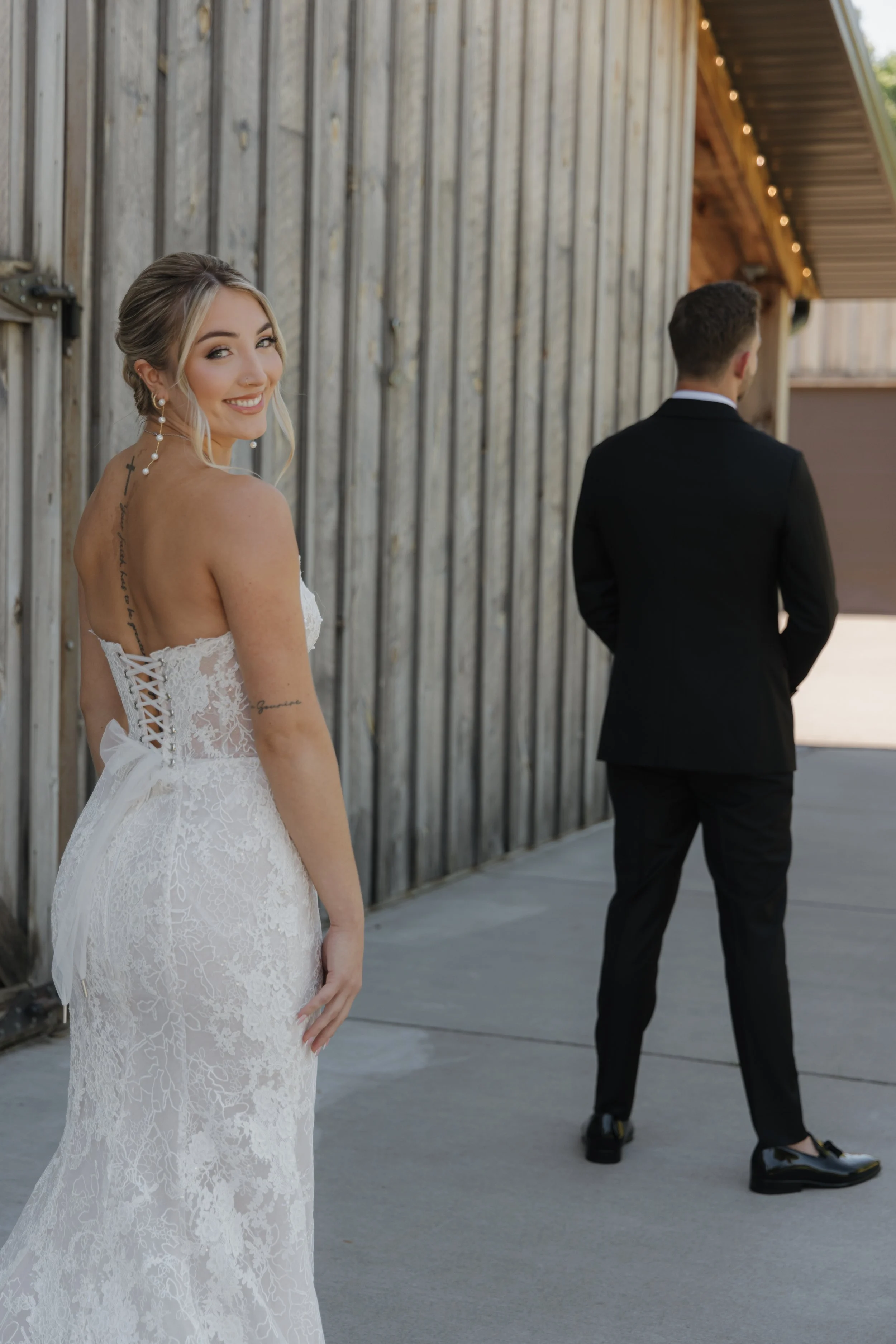 Laurie’s customers, Mariana and Carmen holding hands on a green lawn on their wedding day.