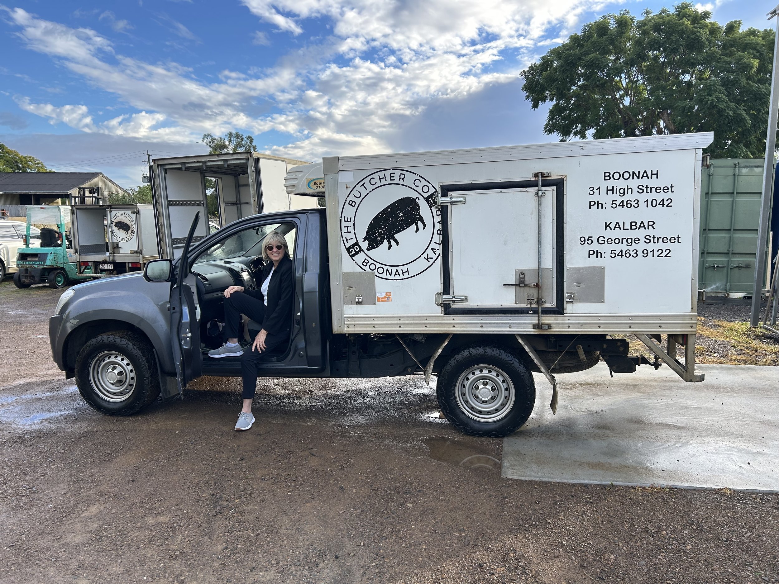 One of the owners of Baribun Farm sitting in the driver’s seat of a refrigerated delivery truck delivering fresh, healthy,  grass-fed beef from the Darling Downs delivered to customers in Brisbane, Queensland - Paddock to Plate.