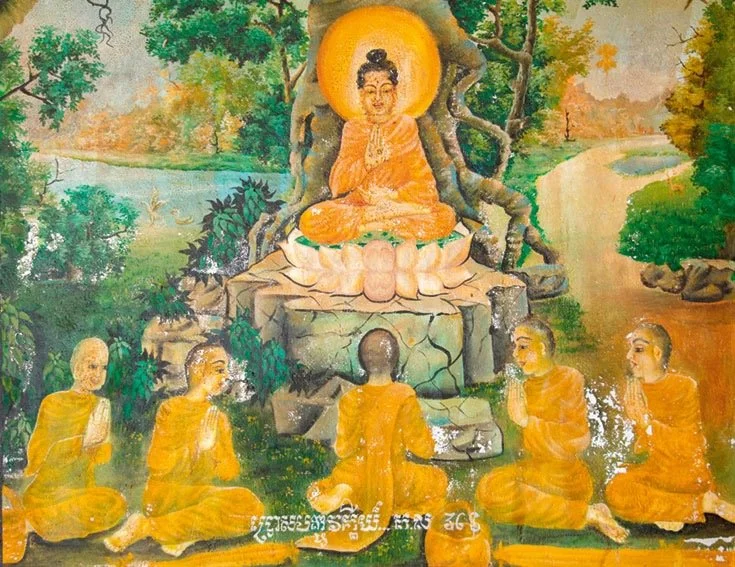 A Buddha statue sitting on a lotus flower on a rock, surrounded by five monks in orange robes sitting in a semi-circle, with a lush green forest and river in the background.