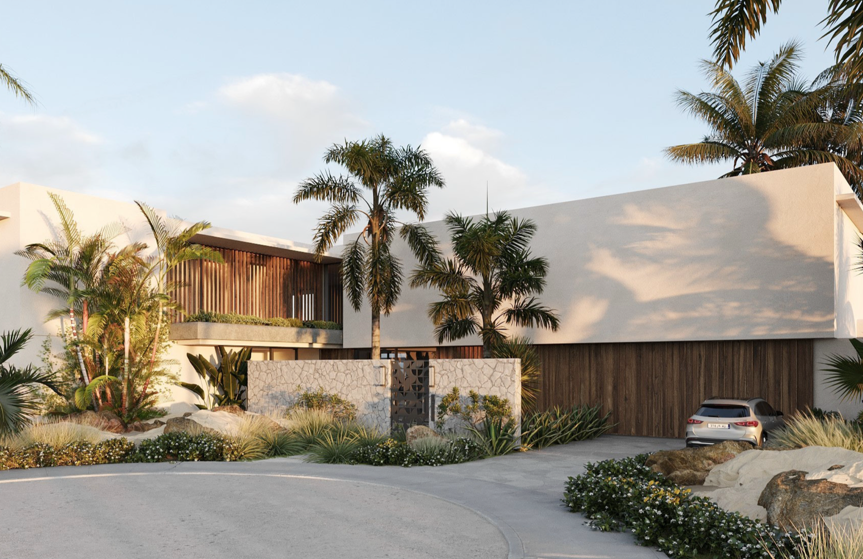 Modern house with white walls and wooden accents, surrounded by tropical plants and palm trees, with a driveway and parked car.