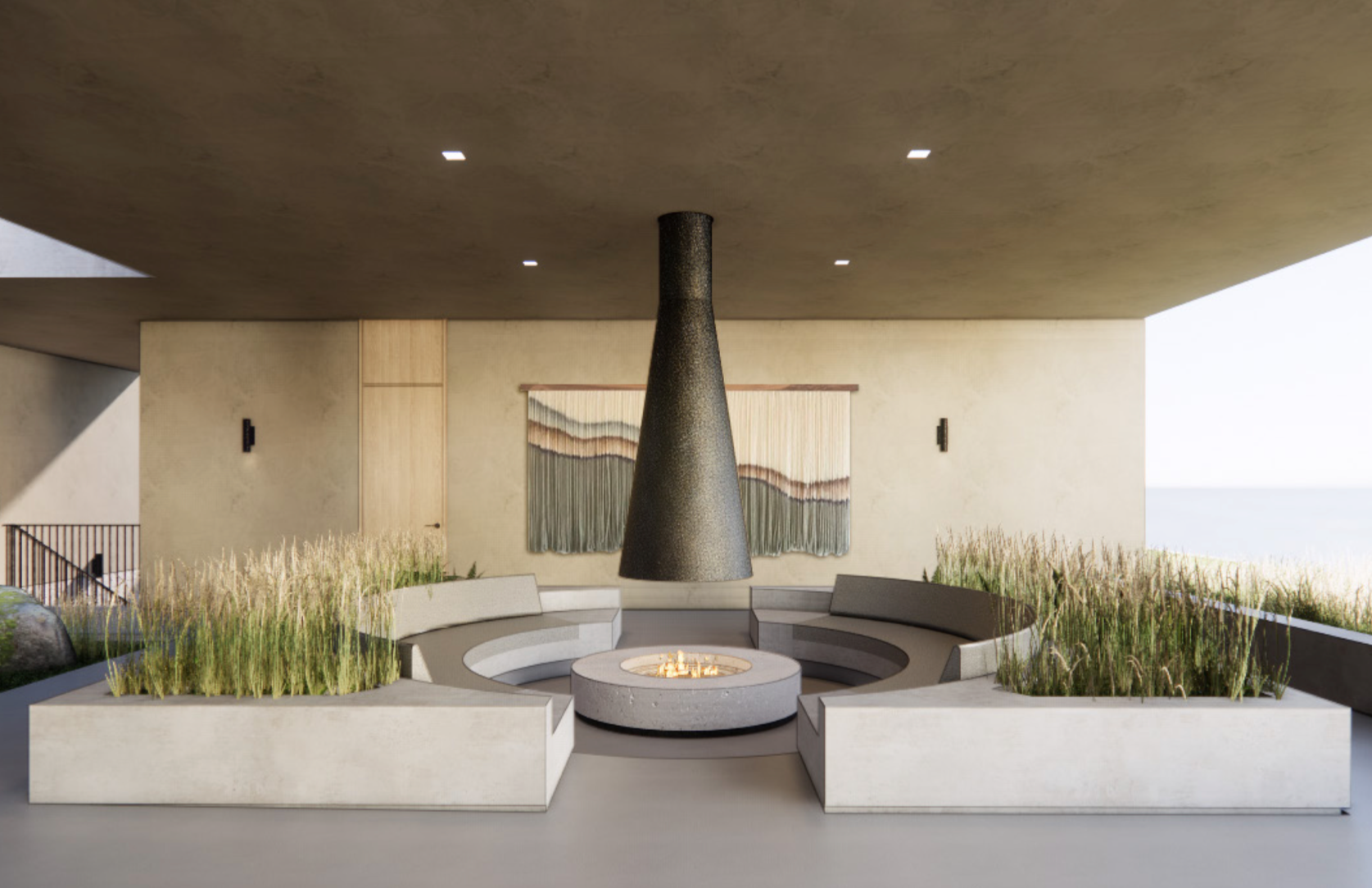 Contemporary outdoor seating area with semi-circular built-in benches around a fire pit, planters with tall grasses, and a hanging cone-shaped fireplace, with a large abstract wall hanging or artwork and a view of the sky or ocean in the background.