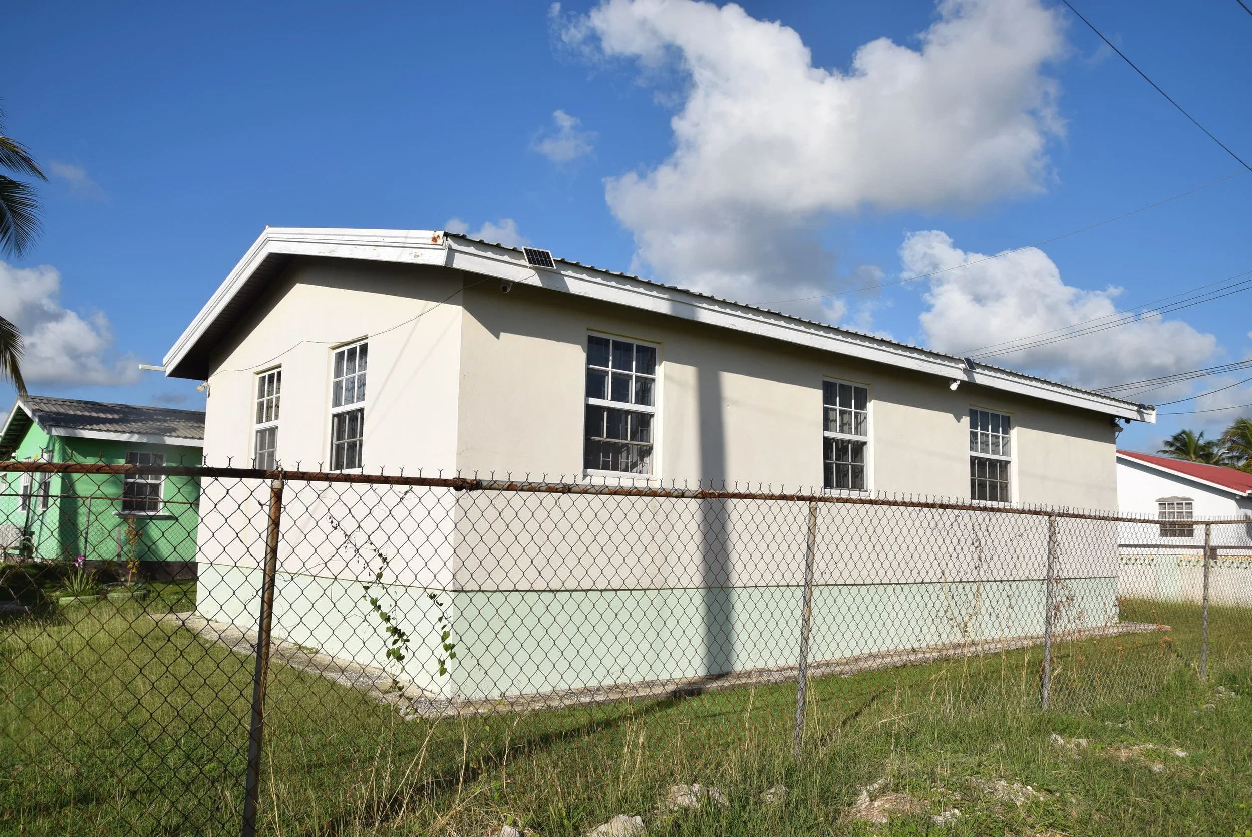 View of SE corner of house, looking NW