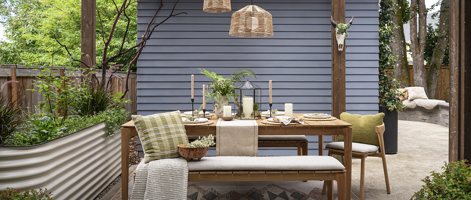 outdoor dining patio in Portland with oak dining table, woven pendant lighting, and garden seating area