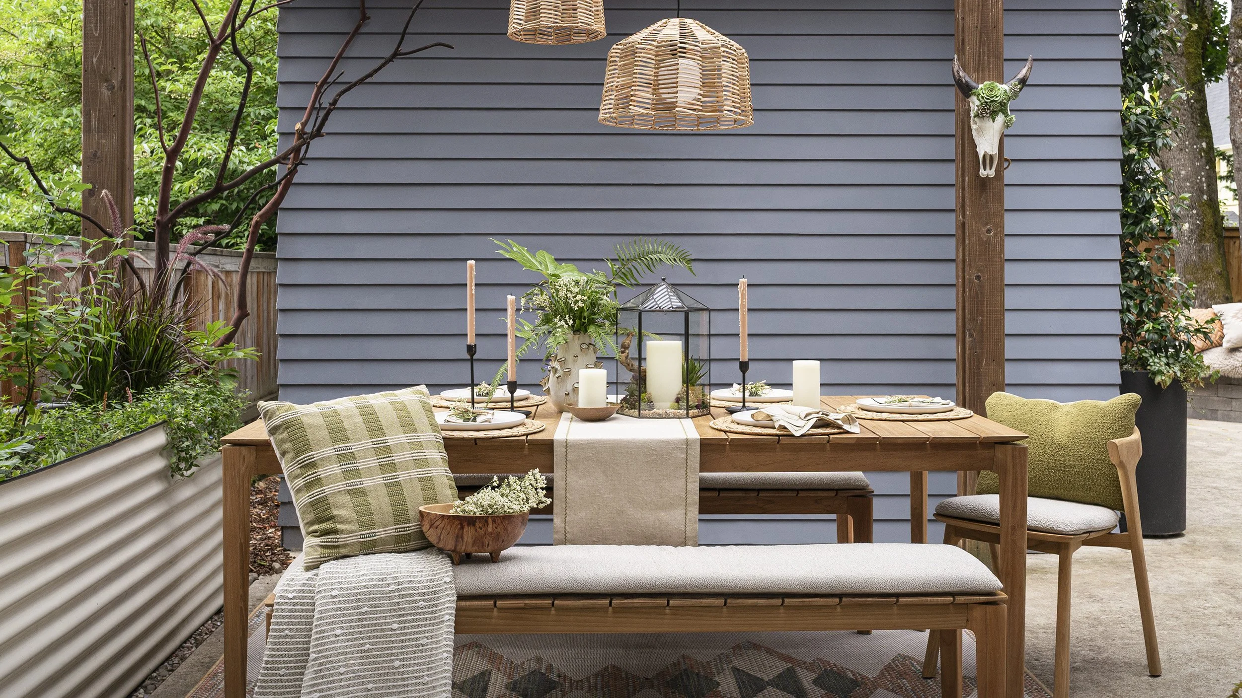 outdoor dining patio in Portland with oak dining table, woven pendant lighting, and layered garden seating