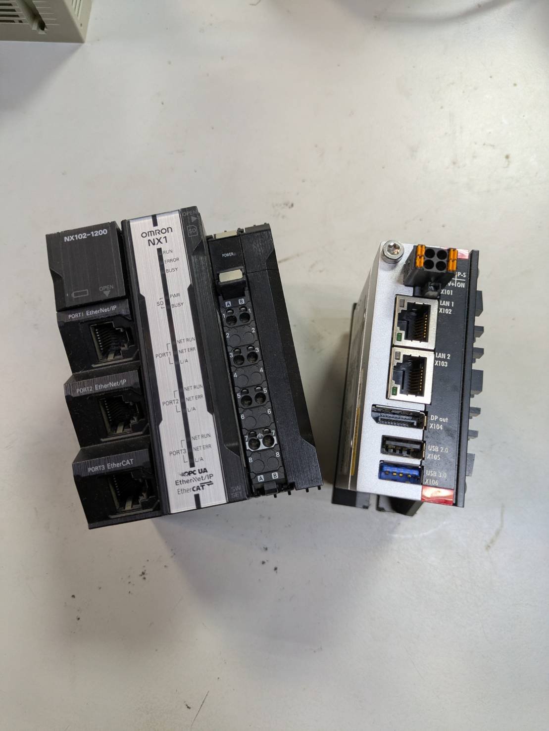 A photo showing two industrial automation control modules placed on a light-colored surface.