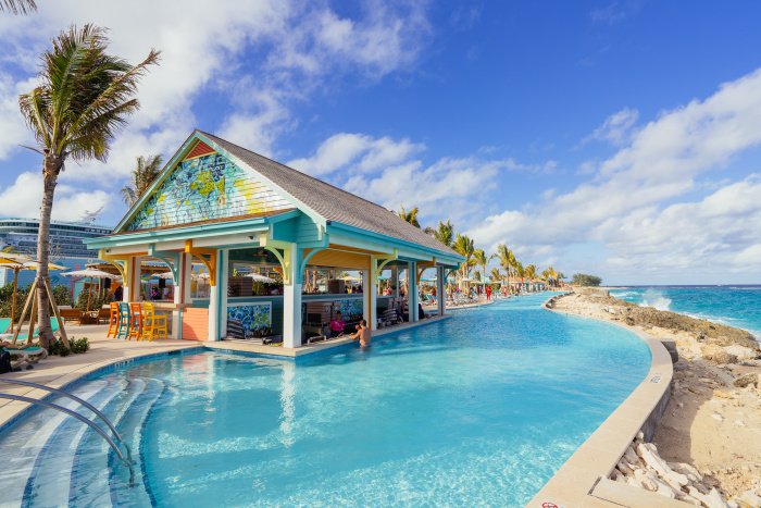 Infinity pool and beach bar at Royal Beach Club Nassau overlooking turquoise water