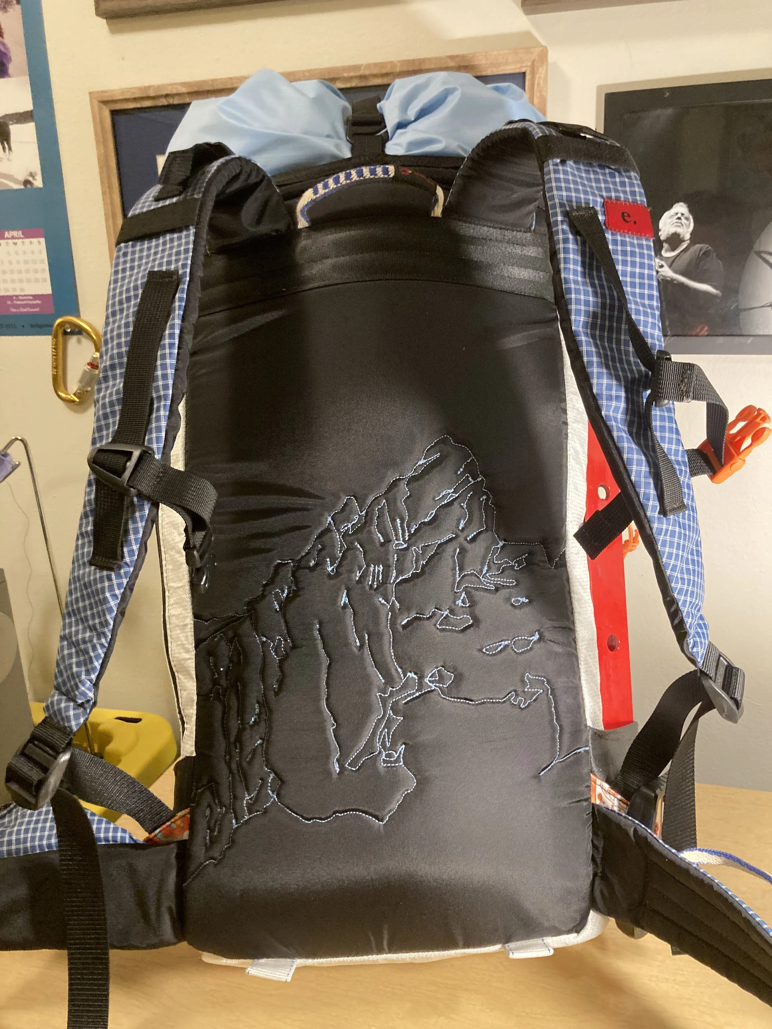 Completed pack showing the back panel art and recycled sling grab handle.