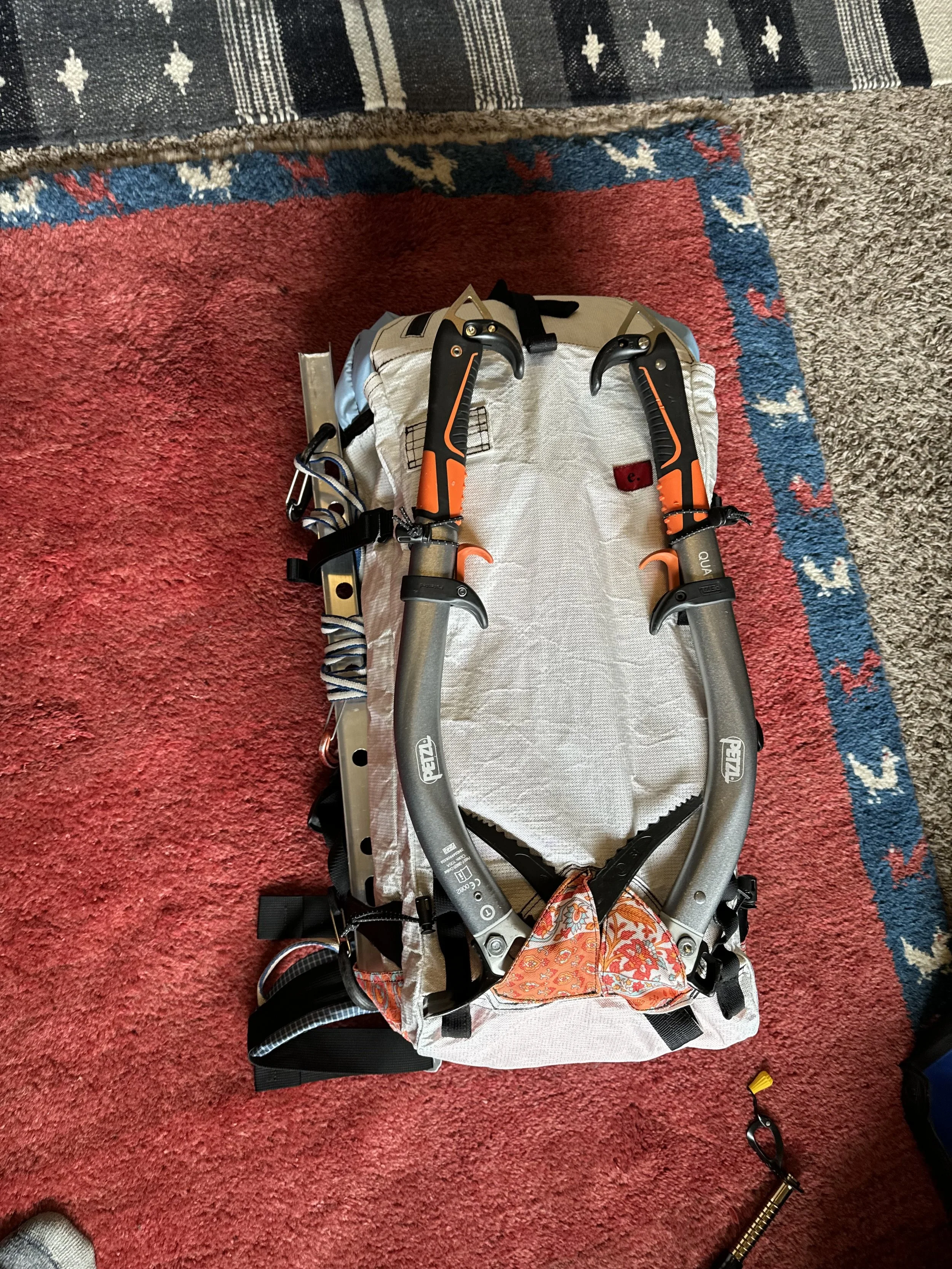 Dual ice tool carry and a glimpse of the hip belt with gear and ice clipper loops.