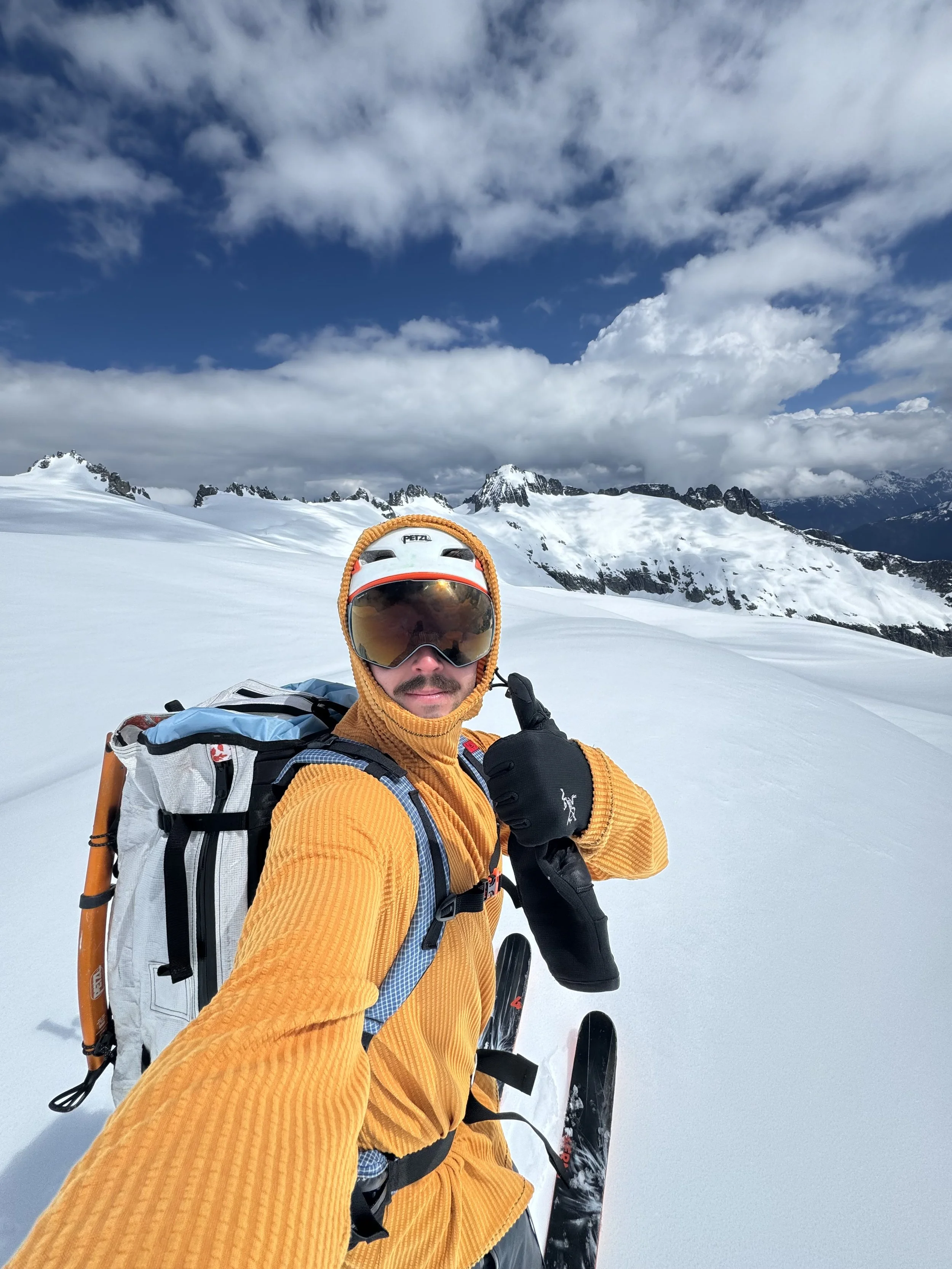 Matt with his pack, highlighting the side zipper access and stretchy hip belt pocket.