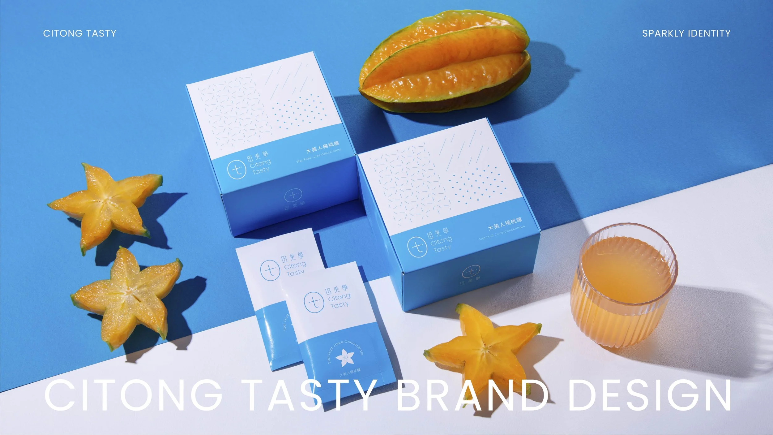 A flat lay of citrus fruit products, including starfruit slices, a whole starfruit, and a half starfruit, along with a glass of juice, all arranged on blue and white backgrounds. There are two blue and white boxed juice containers and some juice packets with the brand name Citong Tasty.