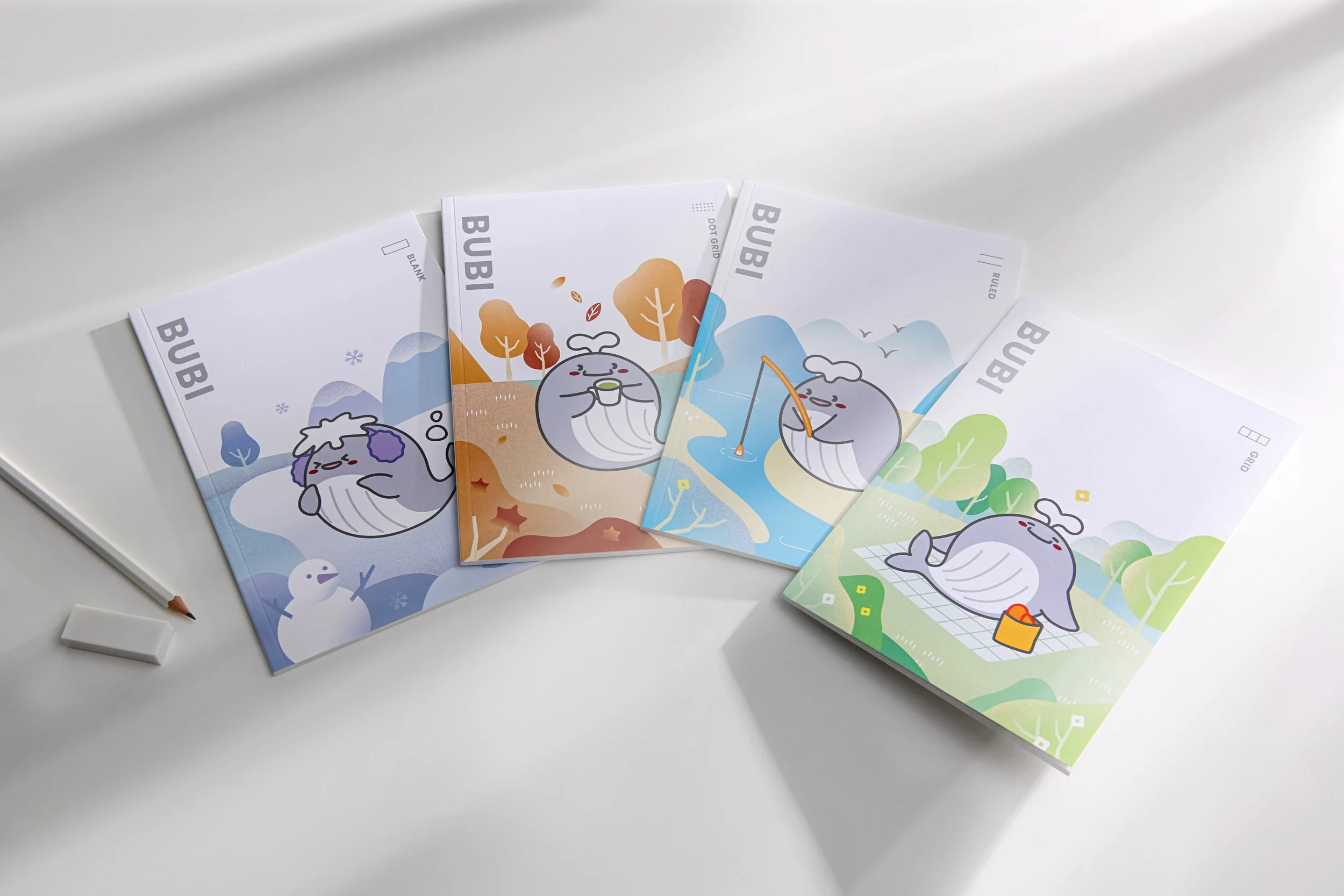 Four colorful illustrated sheets featuring a cute whale character, each engaging in outdoor activities like snowball fighting, autumn leaf gathering, fishing, and having a picnic.