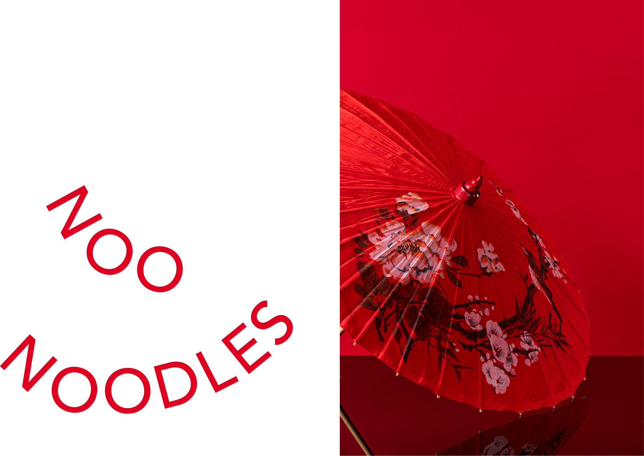 A red Asian-style paper parasol with floral design, reflected on a glossy surface with a red background.