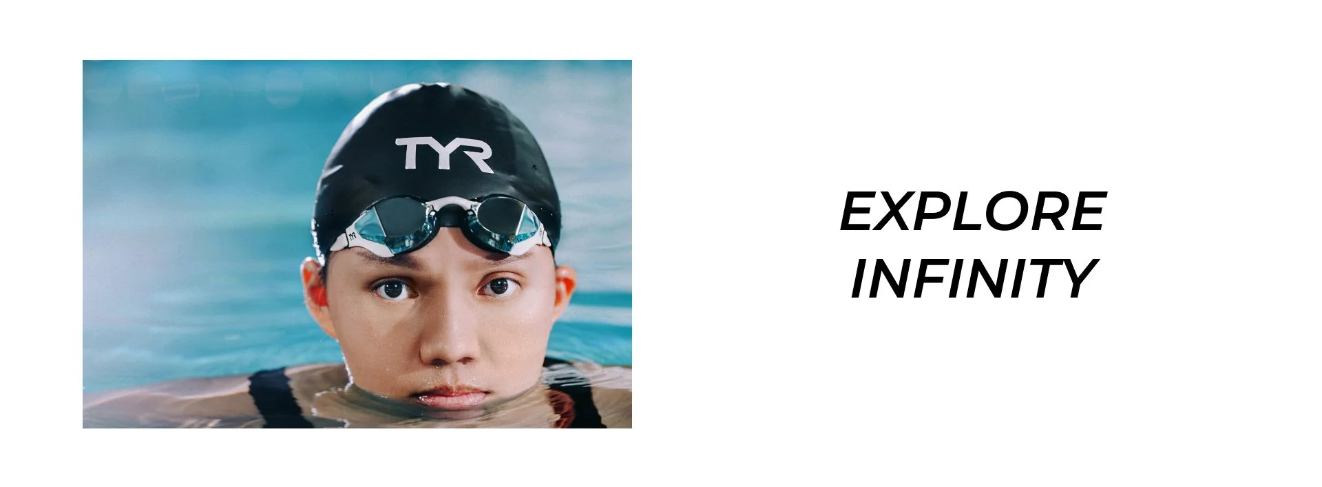 A swimmer wearing a black TYR swim cap and goggles looking directly at the camera, with water surrounding them.