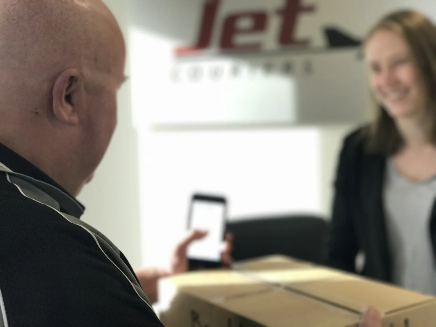 Jet Couriers team member assisting a customer