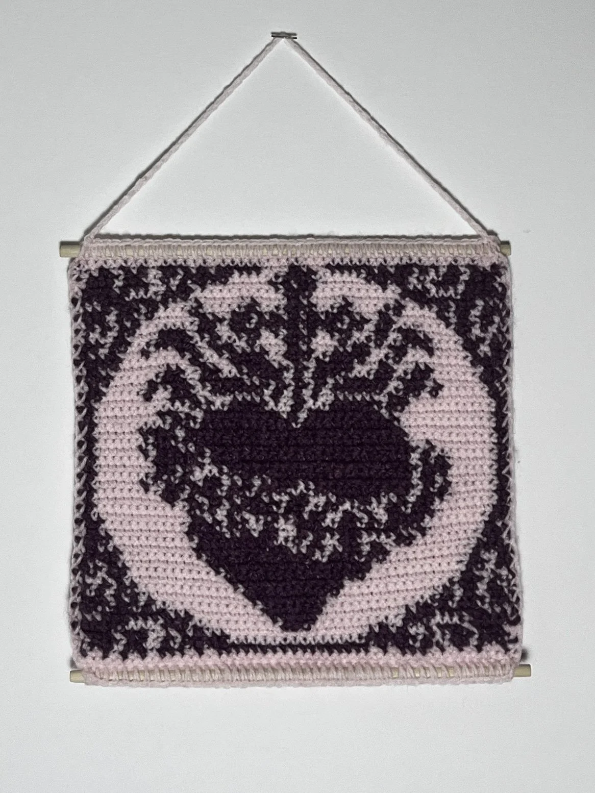 Sacred Heart, 9.5(14 hanging) x 9.75", cotton and acrylic yarn, wooden rods, 2025