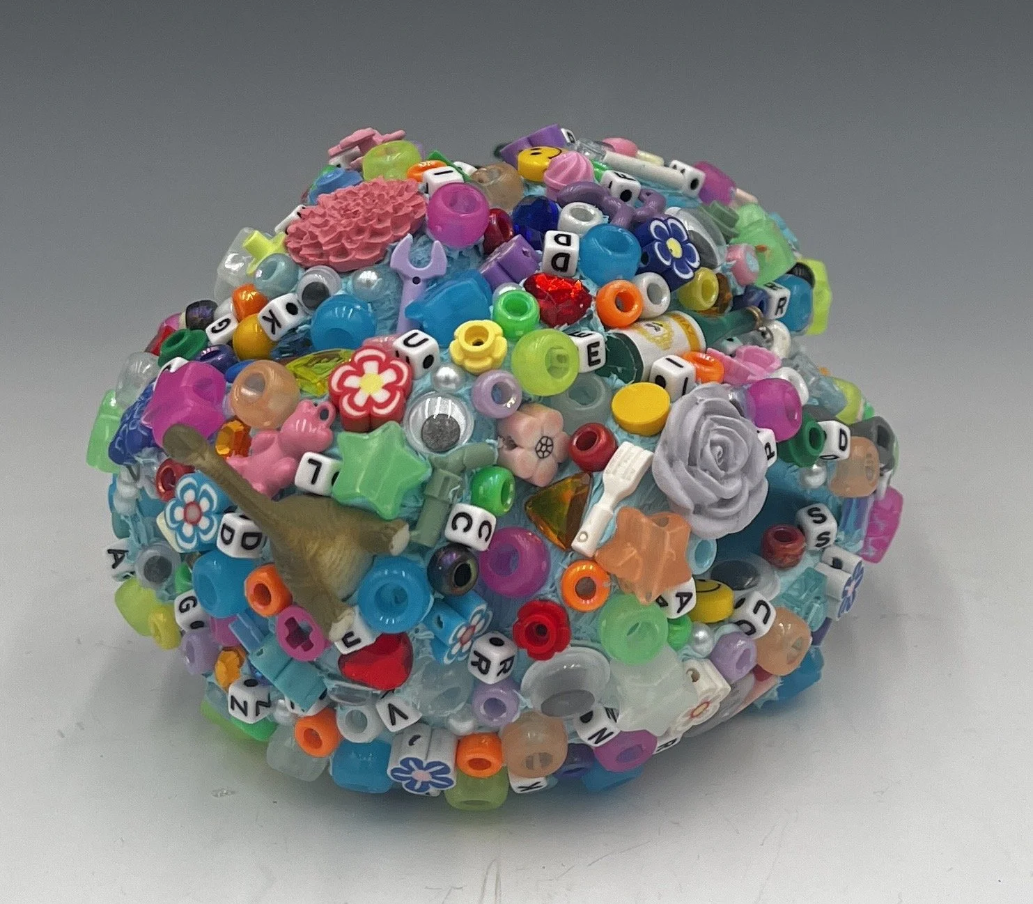 Glob #4, 3.5 x 7 x 4.5”, Ceramic, acrylic paint, found plastic objects, 2025