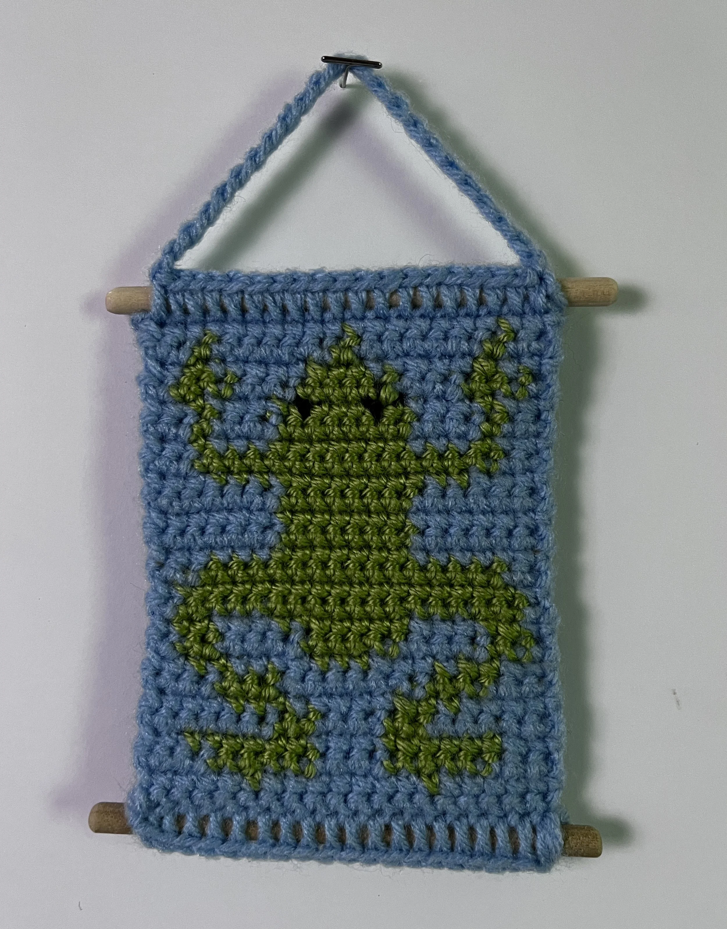 Frog, 5.5 x 5”, acrylic yarn, wooden dowels, felt, 2026