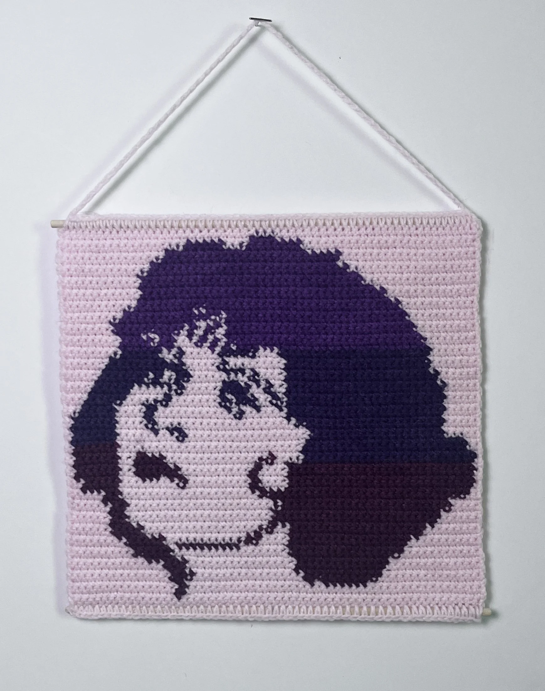 Clara Bow, 10 x 10.5”, acrylic yarn, wooden dowels, felt,  2026