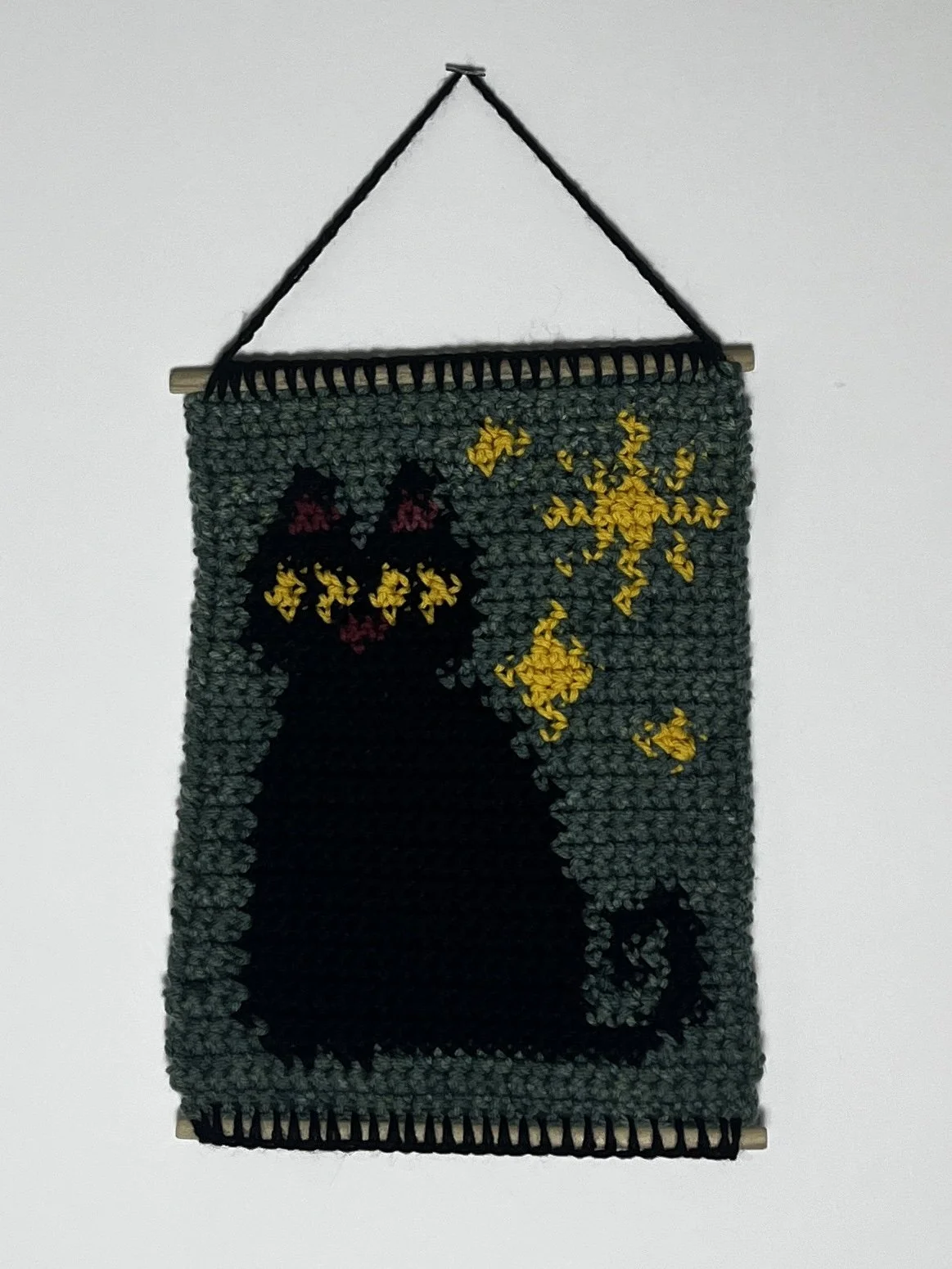 Starry Kitty, 10.5(14.5 hanging) x 8", acrylic yarn, wooden dowels, 2025
