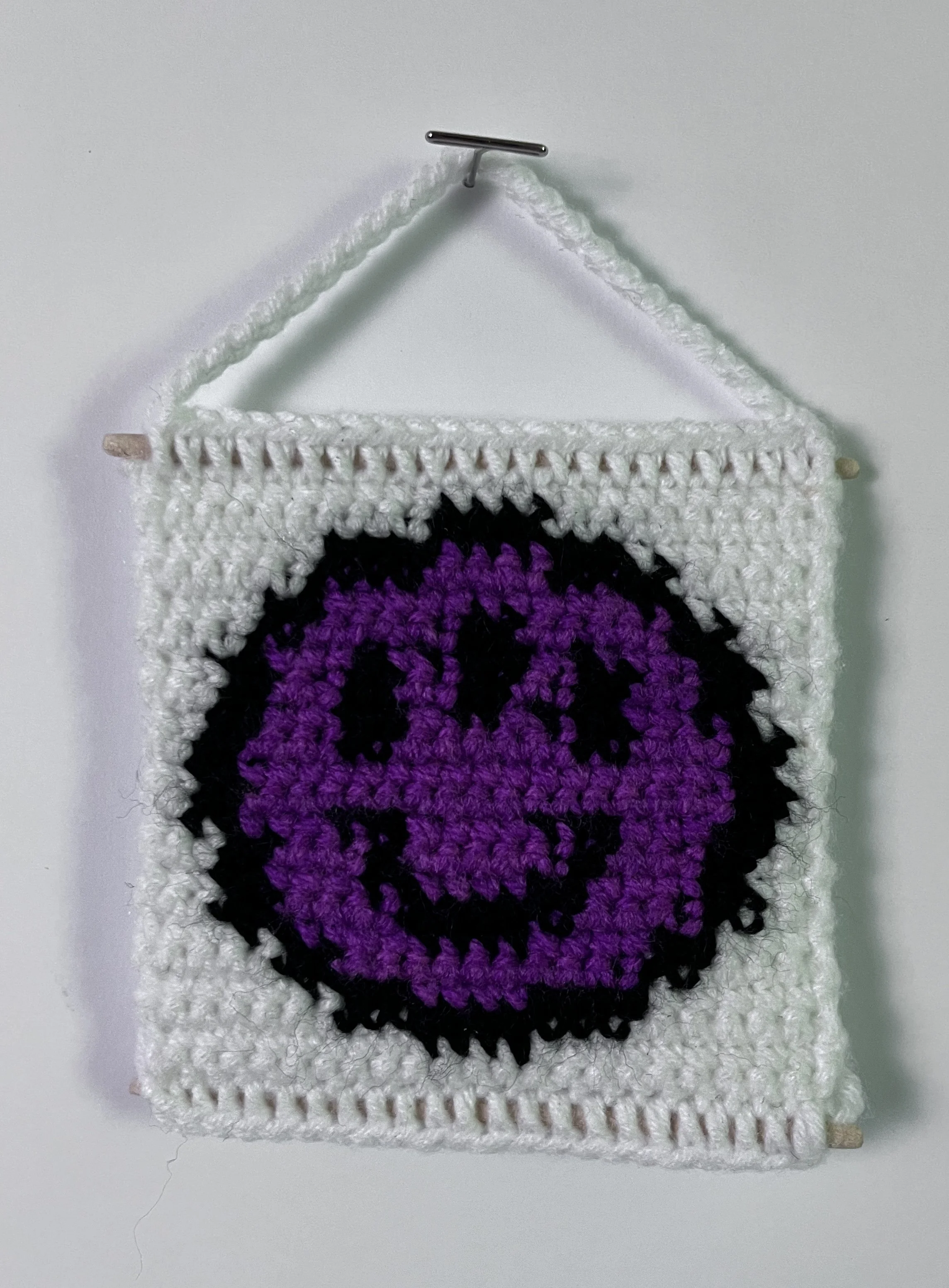3 Eyed Smiley, 3.5 x 3.5”, acrylic yarn, wooden dowels, felt, 2026