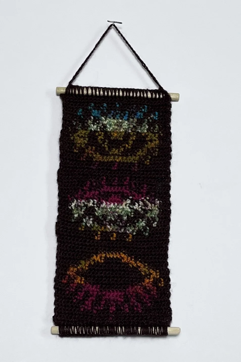 Third Eye, 9 x 4.5”, acrylic yarn, wooden dowels, felt,  2026