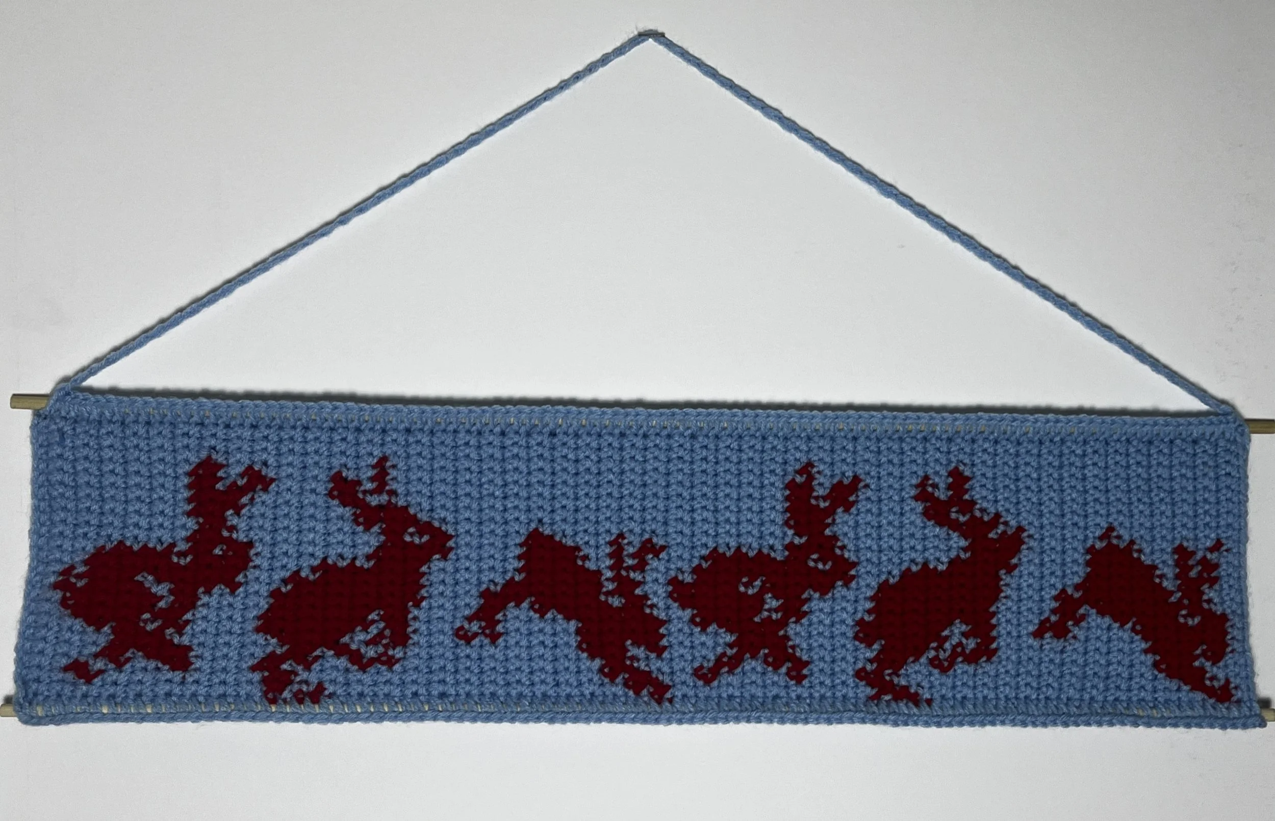 Bunnies, 6.5(14.5 hanging) x 26", acrylic yarn, wooden dowels, 2025