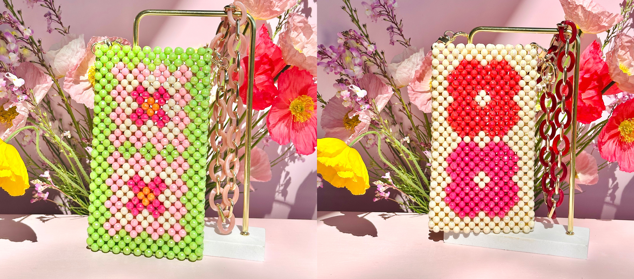 A beaded purse with a flower design, displayed on a stand with a gold chain, pink flowers, and a pink background.